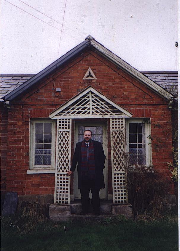 Stephen Roberts standing in the porch of the cottage